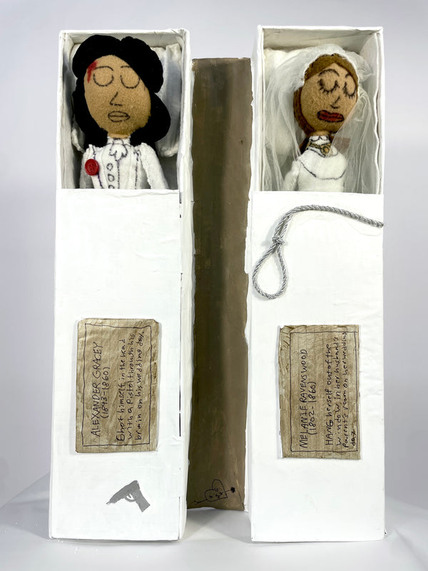 Two dolls in boxes with text labels on a white background