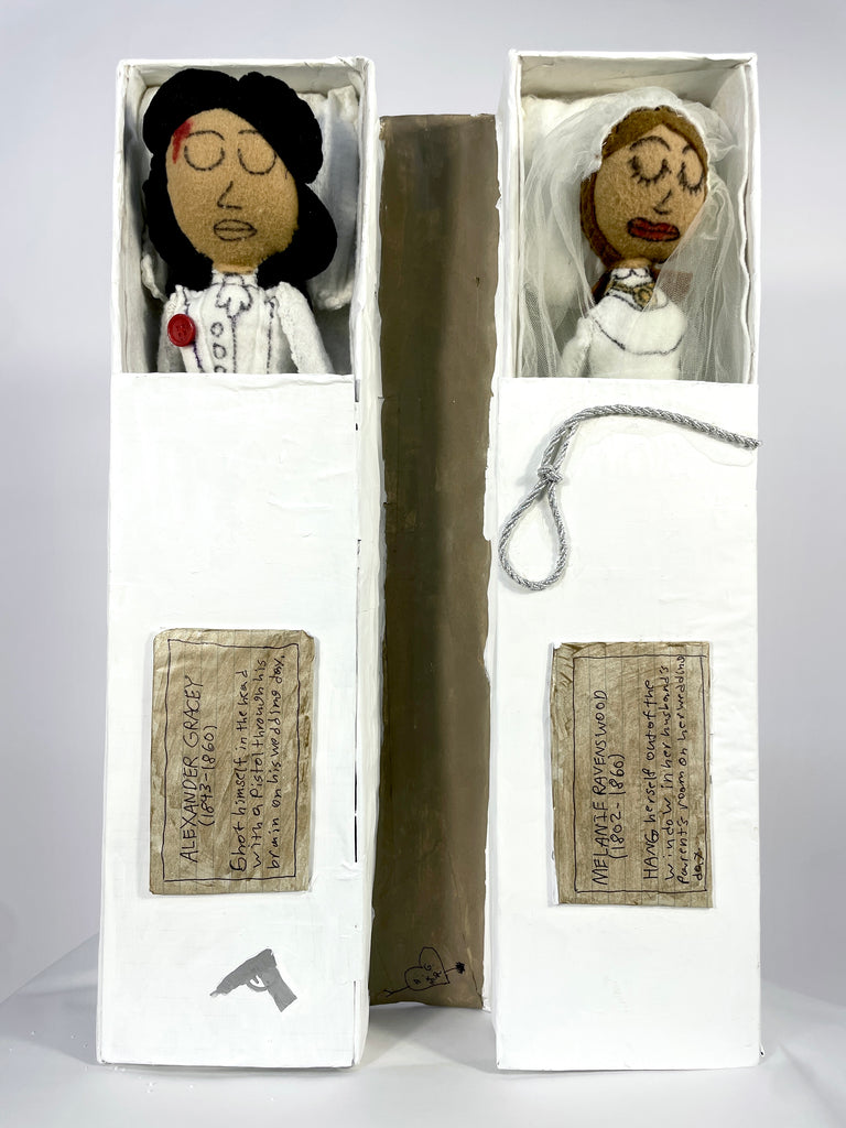 Two dolls in boxes with text labels on a white background